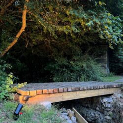 Directional spotlight installed to illuminate the bridge over the brook