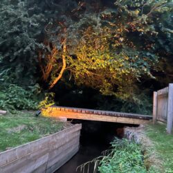 Directional spotlight installed to illuminate the bridge over the brook